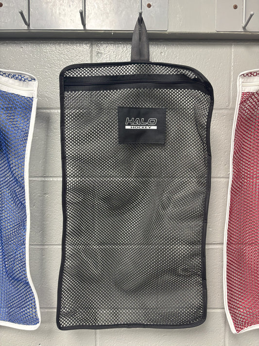 Halo Hockey Stinky Boy laundry bag in black shown hung on a locker room wall hooks