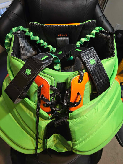 Black carbon fiber suspenders 2.0 with neon green logos and center strap option installed on matching Vaughn goalie pants