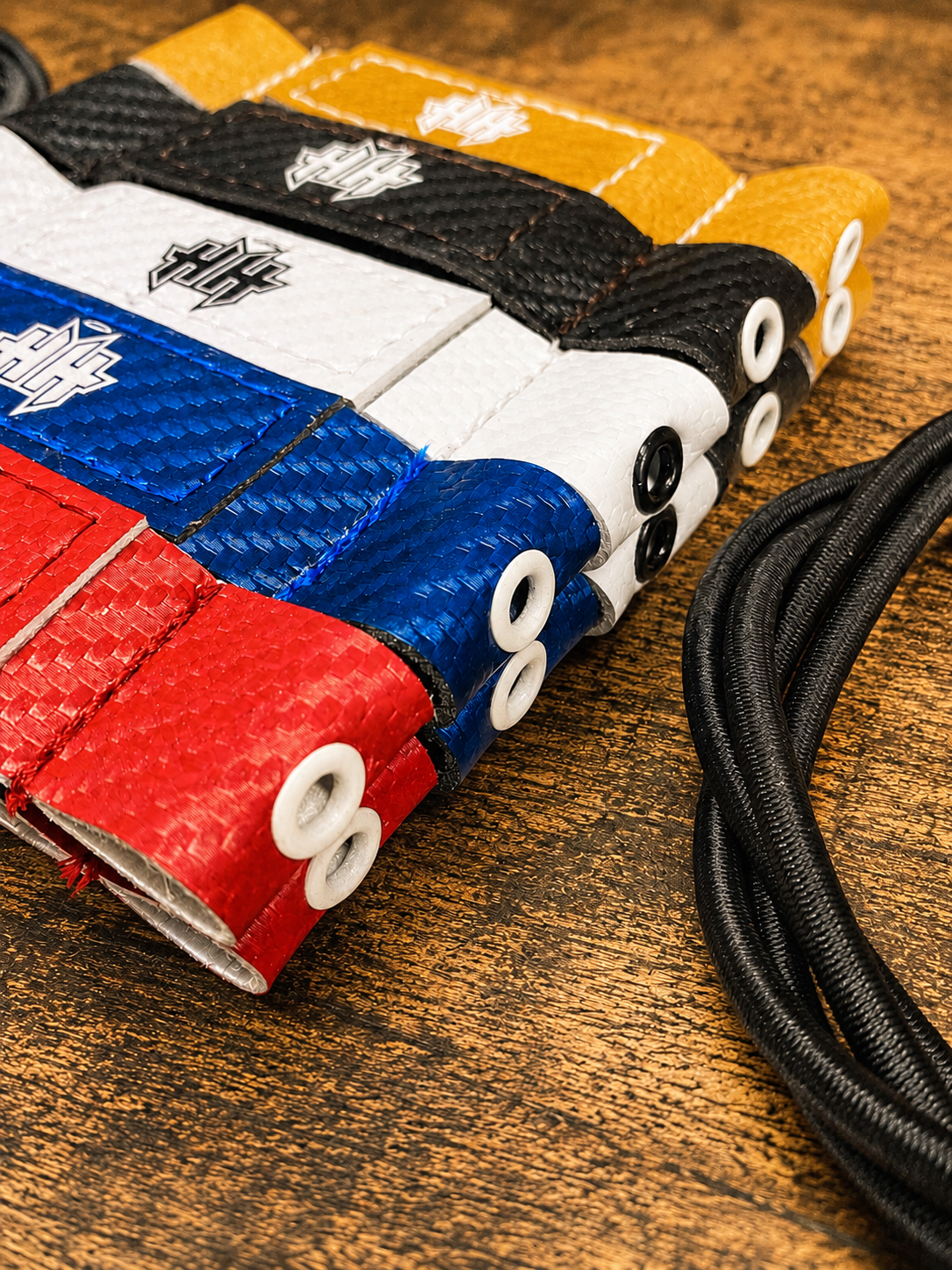Closeup detail of the reinforcement eyelet on the 5 stock colors of Halo Hockey Posi-Lock goalie toe ties
