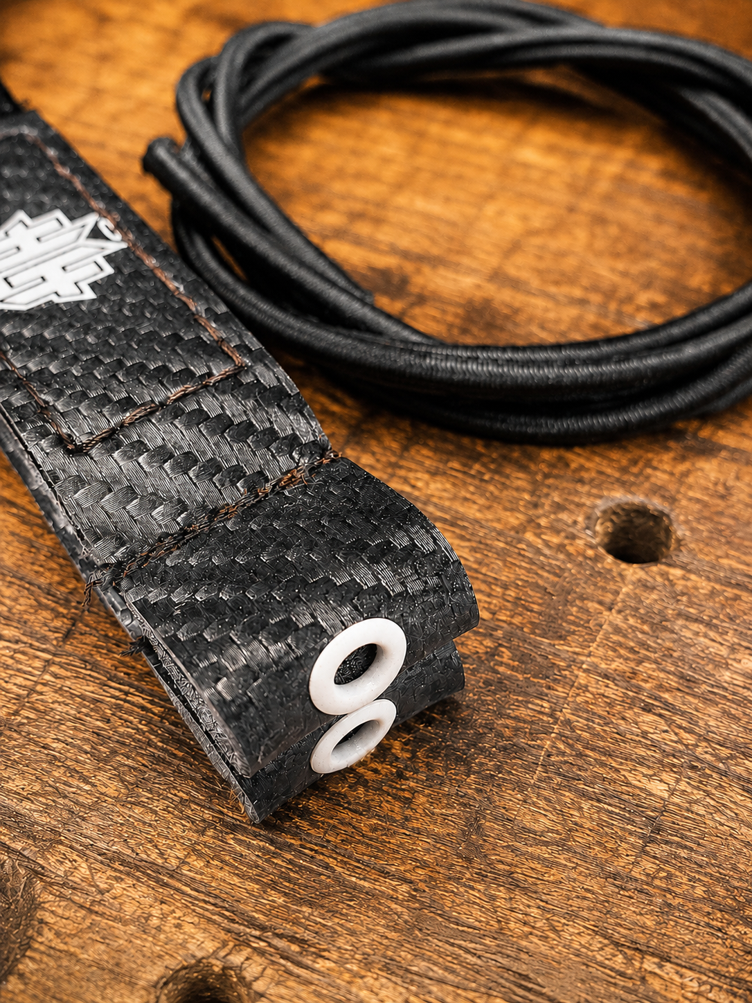 Closeup detail of the reinforcement eyelet on black Halo Hockey Posi-Lock goalie toe ties
