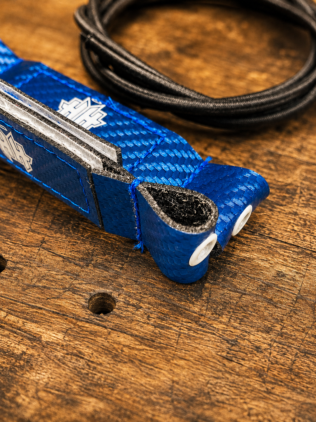 Closeup detail of the reinforcement eyelet and sandwich lock design on blue Halo Hockey Posi-Lock goalie toe ties
