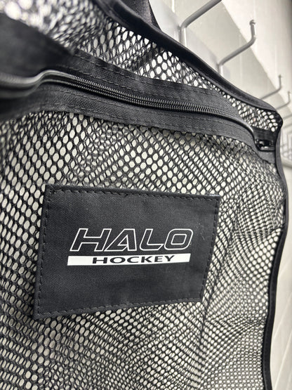 Tilted closeup of Halo Hockey Stinky Boy laundry bag in black color option showing the zipper, logo panel area and stitching detail