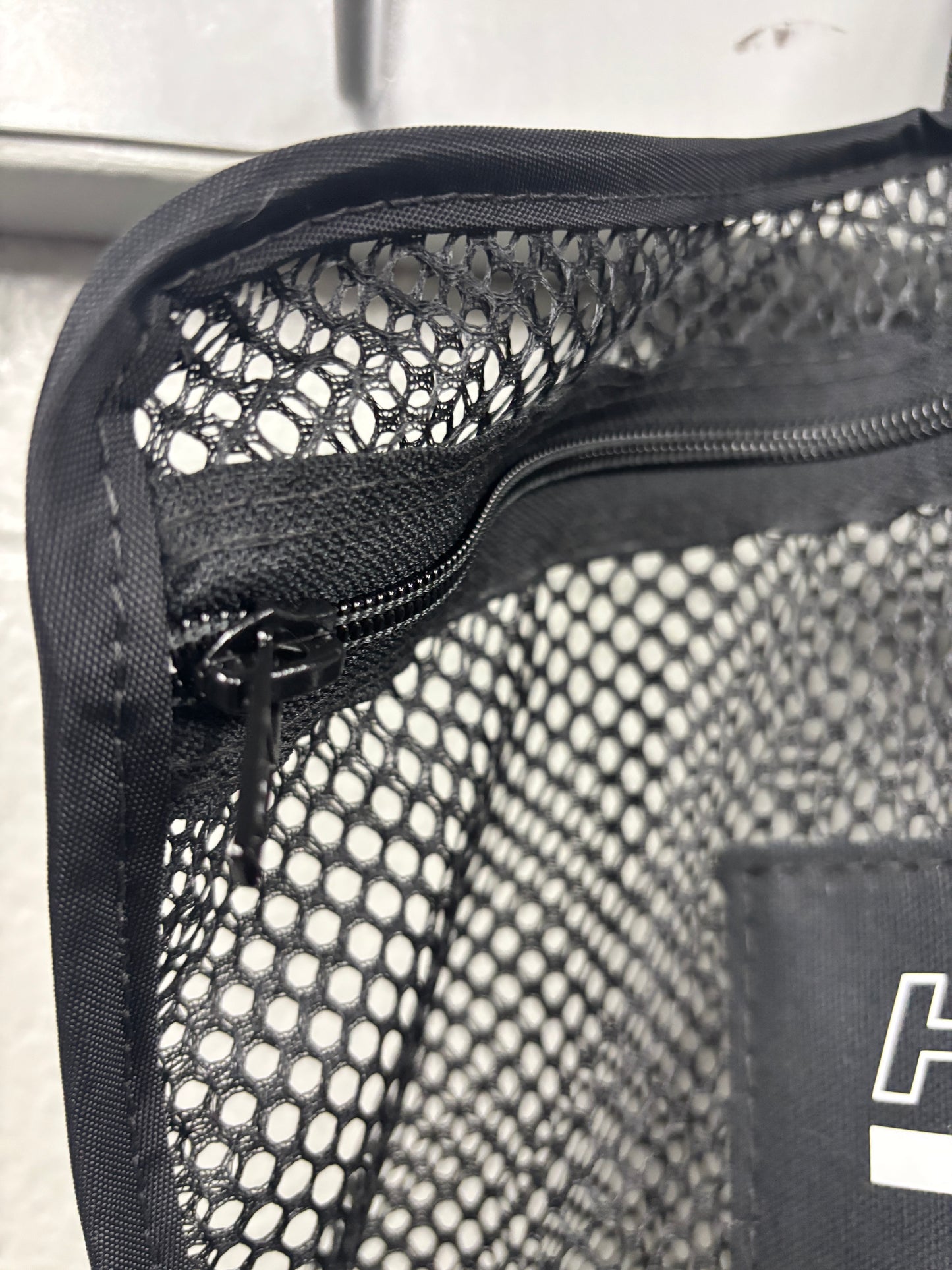 Closeup shot of the binding and zipper area of a black Halo Hockey Stinky Boy Laundry bag