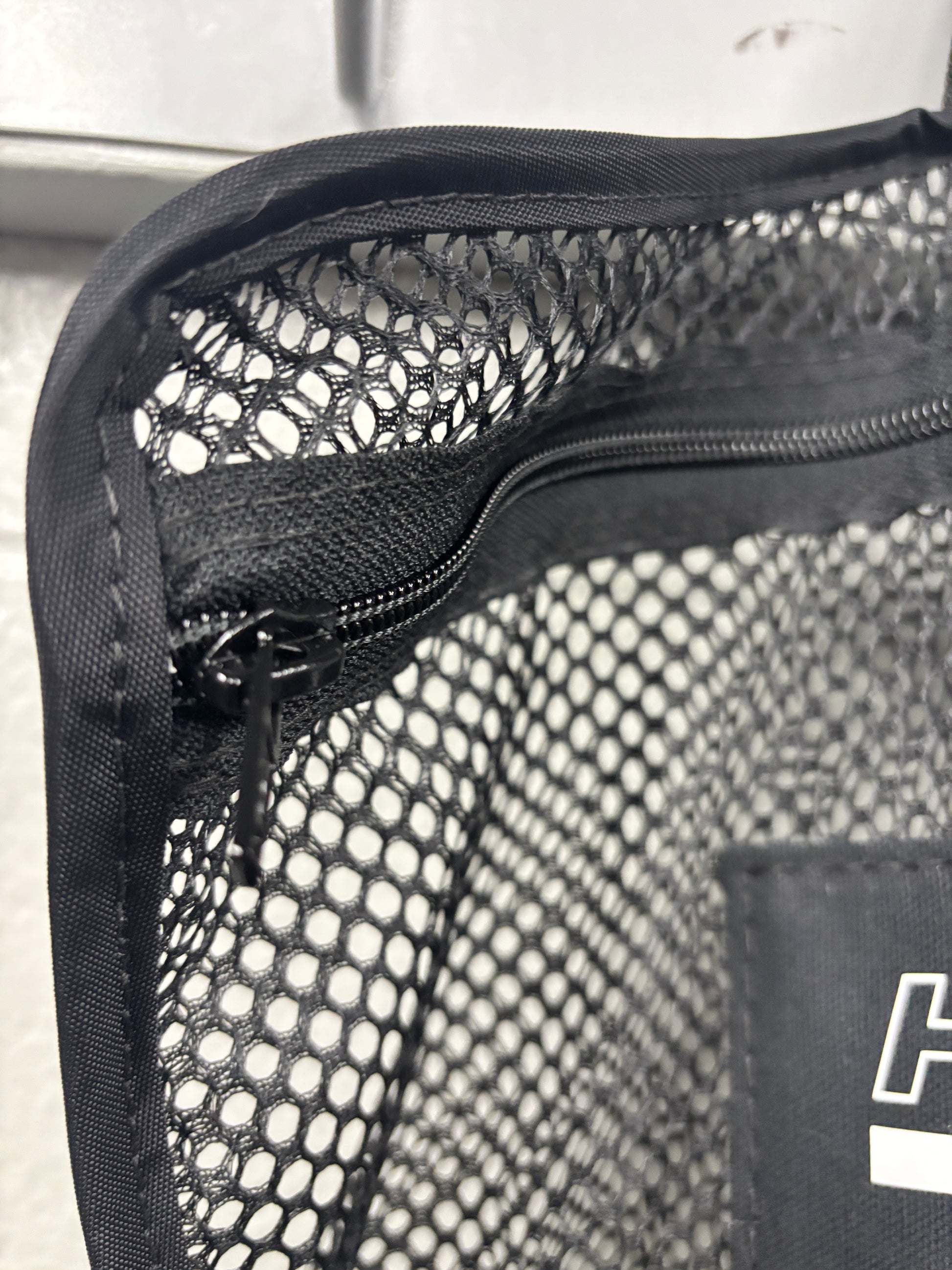 Closeup shot of the binding and zipper area of a black Halo Hockey Stinky Boy Laundry bag