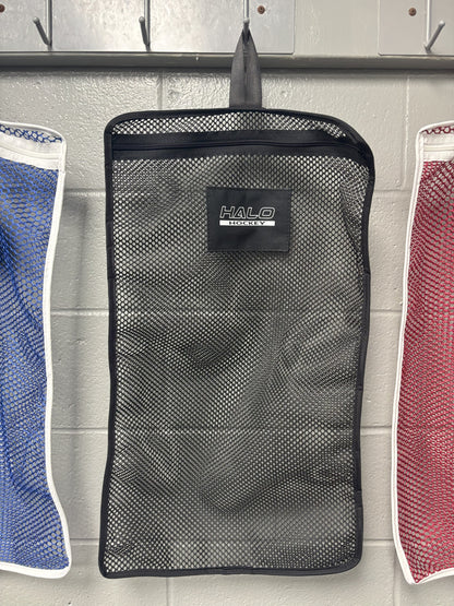 Halo Hockey Stinky Boy laundry bag in black shown hung on a locker room wall hooks