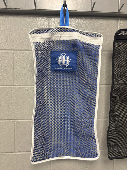 Halo Hockey Stinky Boy Laundry bag shown in blue color option hung on a locker room wall hooks