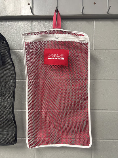 Halo Hockey Stinky Boy laundry bag in red shown hung on a locker room wall hooks