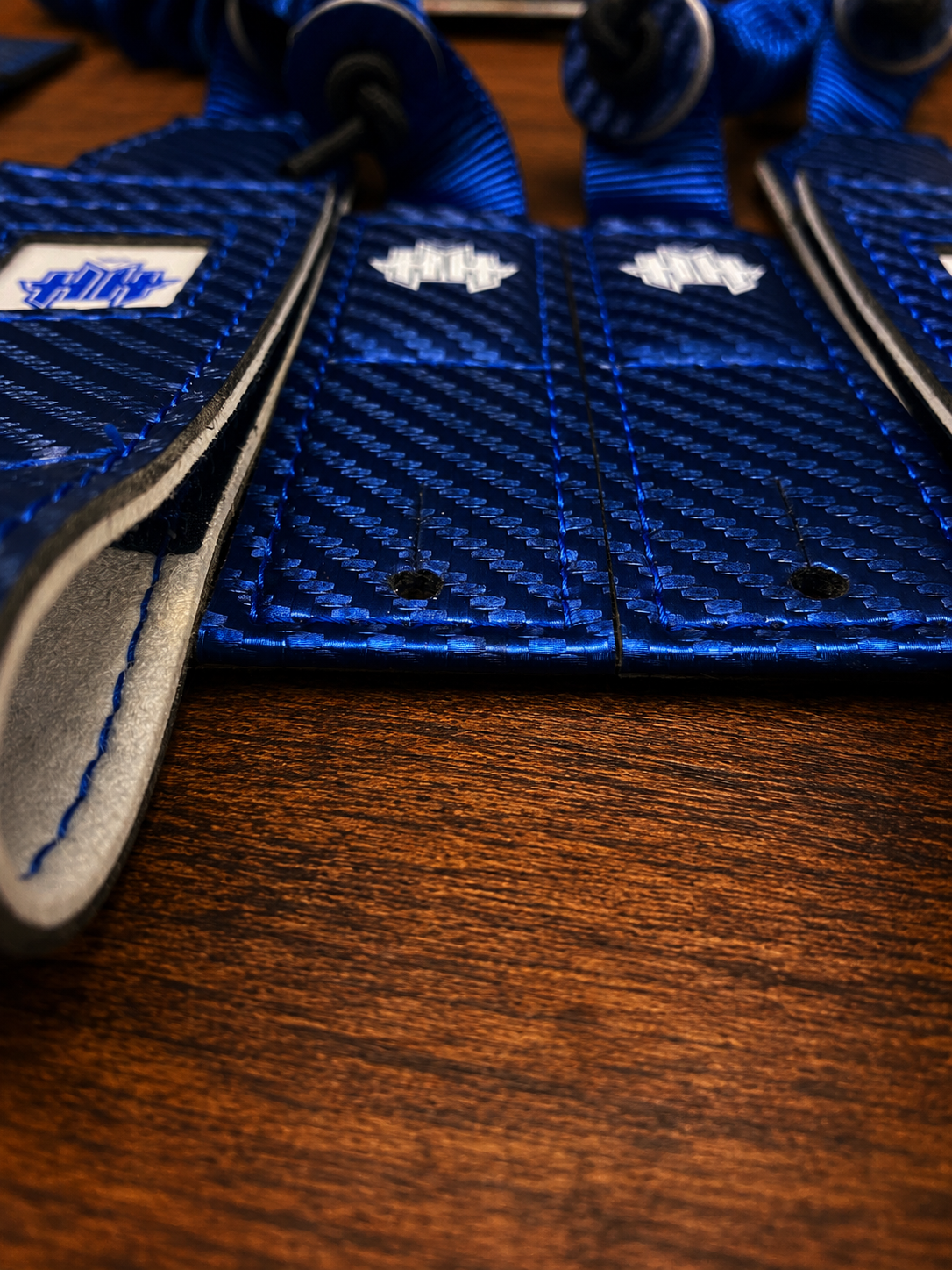Closeup shot of rear mounting tabs on blue Halo Hockey Suspenders 2.0 bungee goalie suspenders