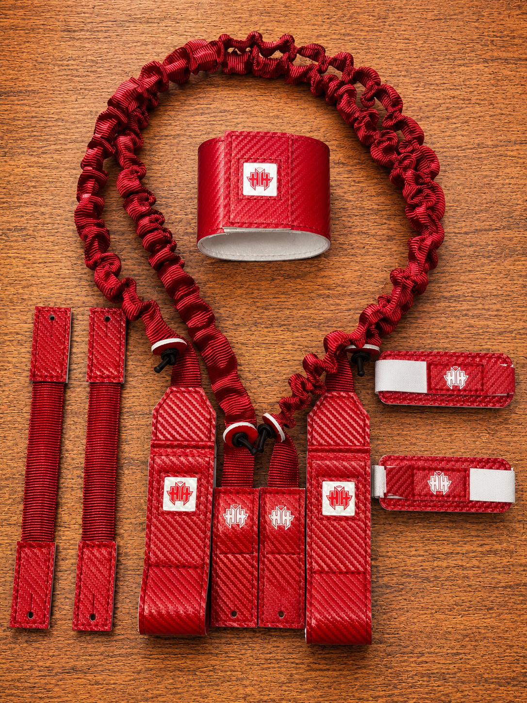 Top kit view of red Halo Hockey Suspenders 2.0 goalie bungee suspenders shown with both shoulder floater attachments and center strap options